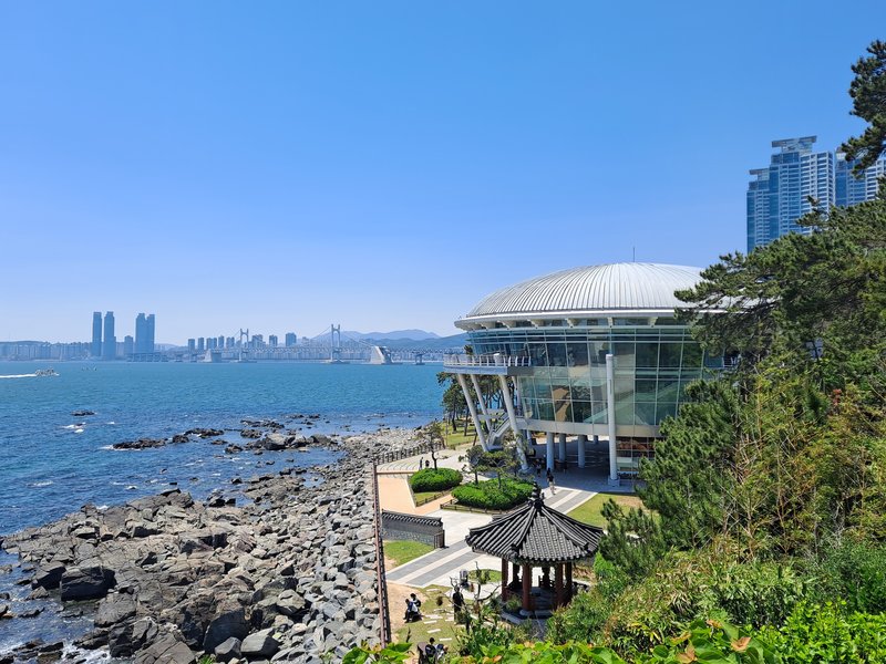 Dongbaekseom promontory with forested coastal trail next to Haeundae Beach