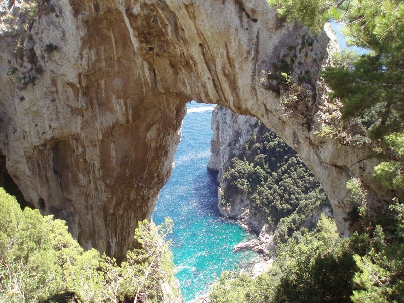 The natural limestone arch of Arco Naturale framing the sea below, Capri