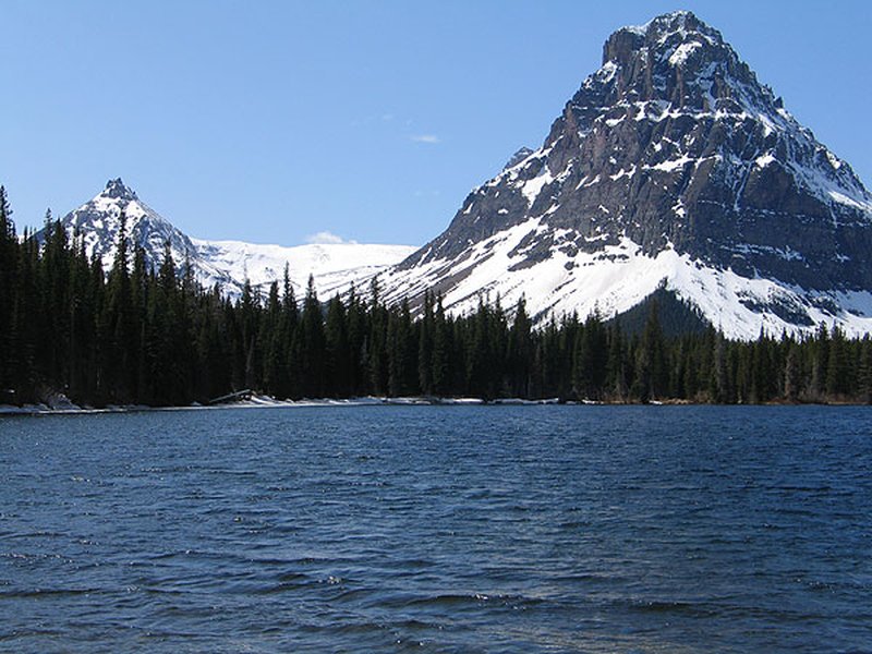 Two Medicine Lake with glacier-carved peaks rising above calm water