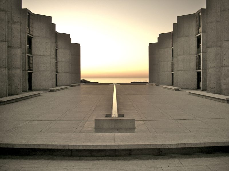 Salk Institute travertine plaza with concrete laboratory towers and Pacific horizon