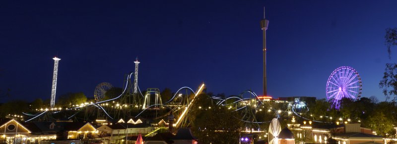 Liseberg amusement park lit up at night, with Helix coaster and Ferris wheel, Gothenburg