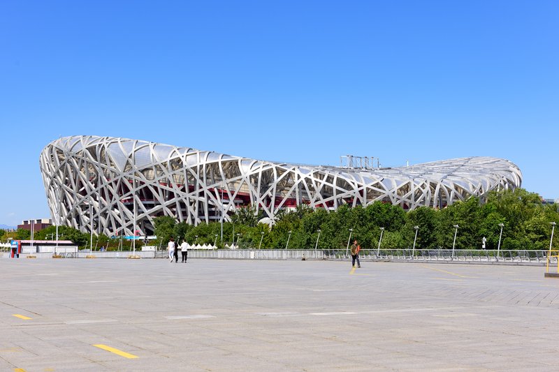 The lattice steel exterior of Beijing National Stadium under clear sky