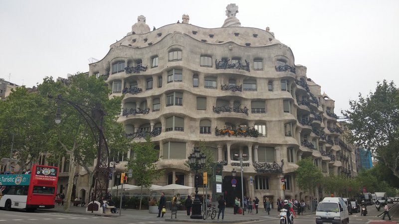 Street-level view of the rippling stone facade of Casa Milà (La Pedrera), Barcelona