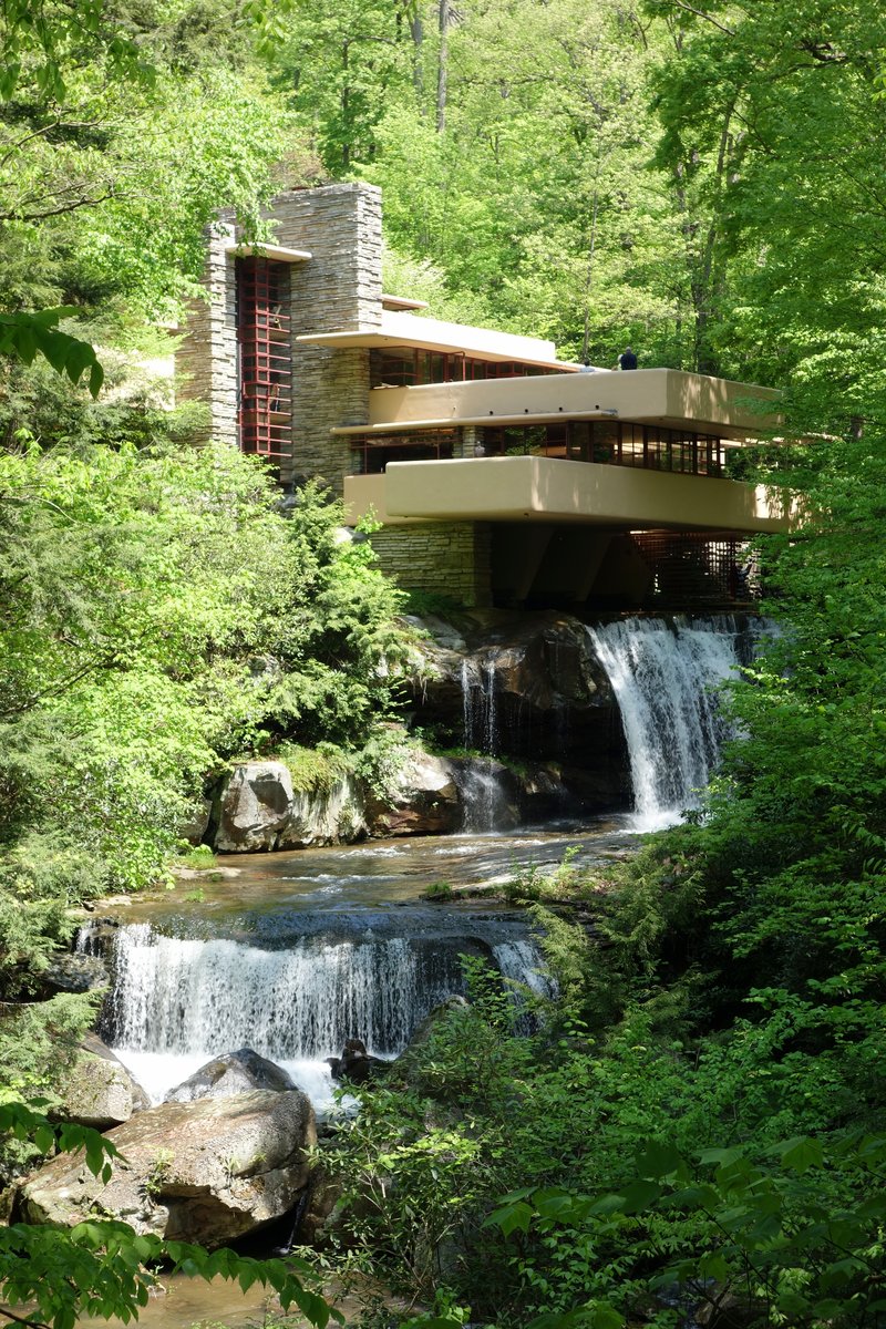 Frank Lloyd Wright's Fallingwater house cantilevered directly over a wooded Pennsylvania waterfall