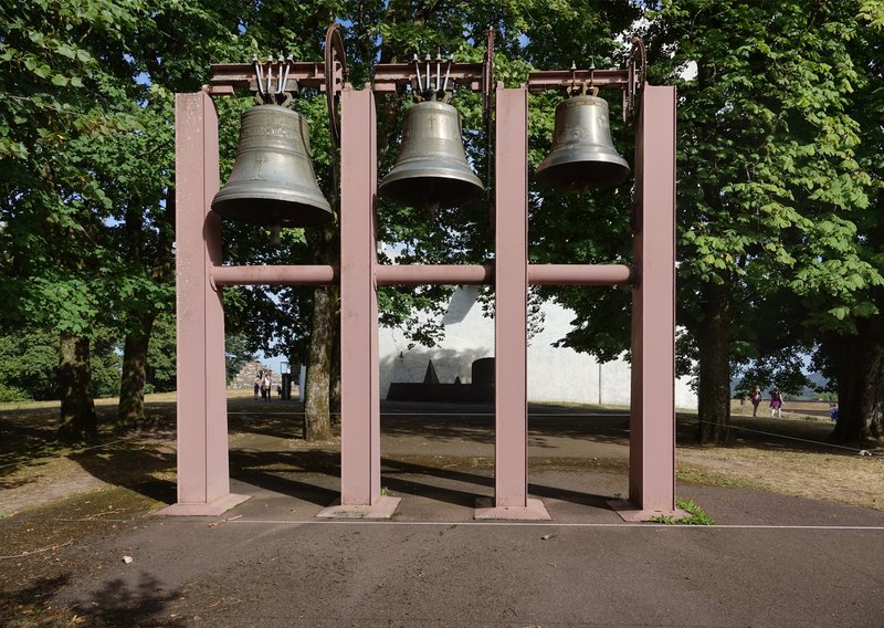 Bell wall with the chapel's curved white roof shell behind, Ronchamp