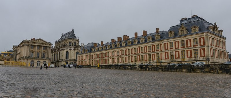 Palace of Versailles facade viewed across the marble courtyard