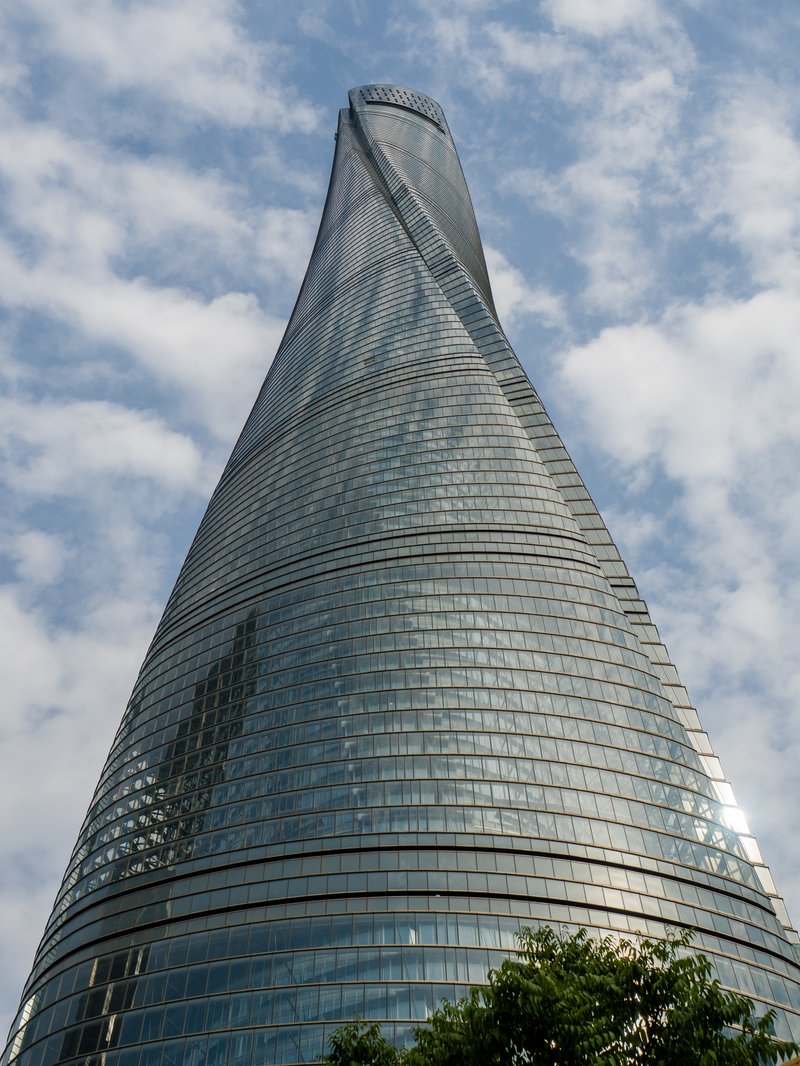 The twisting glass facade of Shanghai Tower rising into the sky