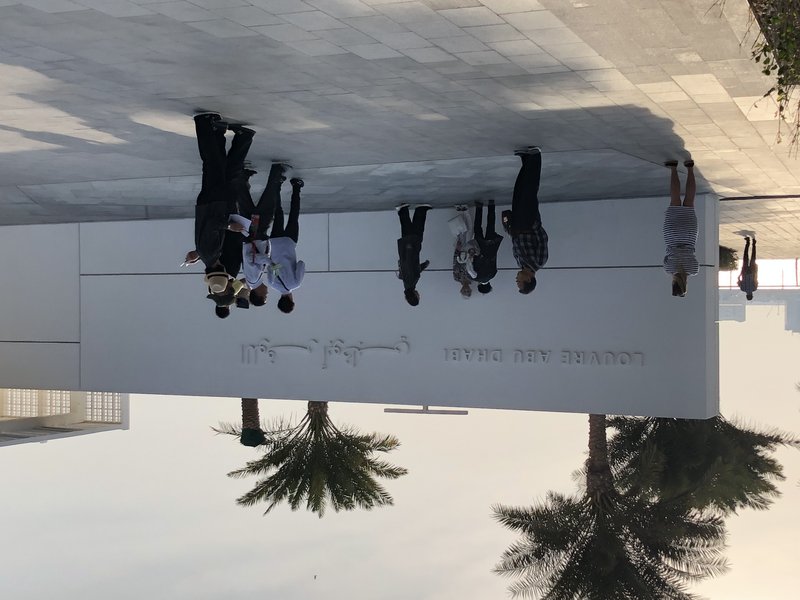 Sunlight filtering through the latticed dome over the reflecting pool at Louvre Abu Dhabi