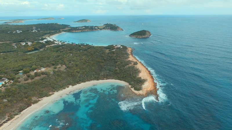 Aerial view of the crescent-shaped Half Moon Bay on Antigua's southeastern coast
