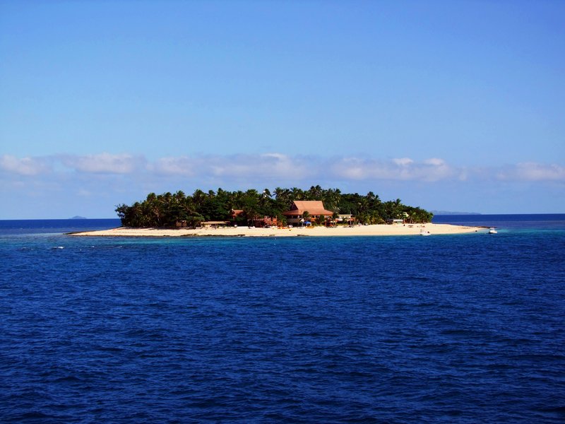 Small private island in Fiji's Mamanuca group ringed by a shallow coral lagoon