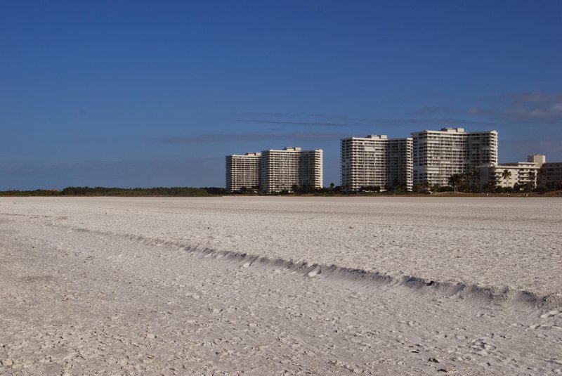 Calm Gulf water and wide pale sand on Marco Island, Florida