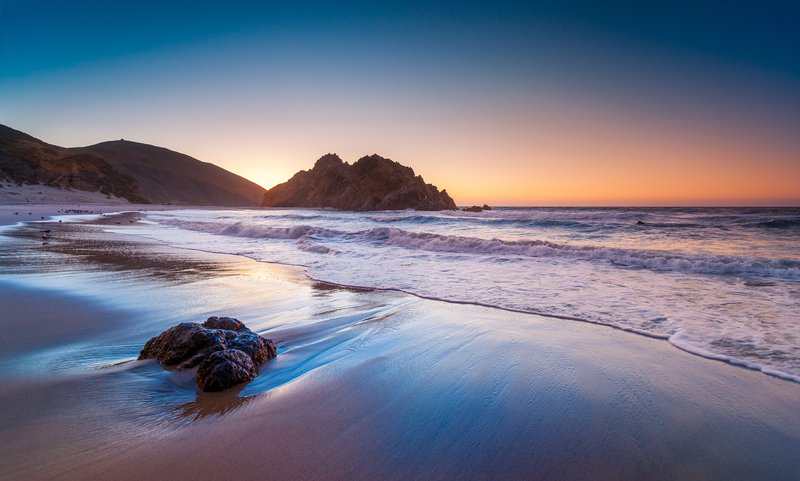 Pfeiffer Beach's purple-tinged sand and rock arch at sunset, Big Sur