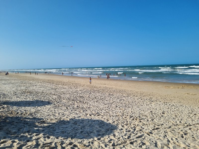 Wide sand and breaking surf at Praia do Futuro in Fortaleza