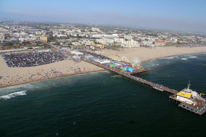 Wide sand and the Santa Monica Pier seen along the California coast