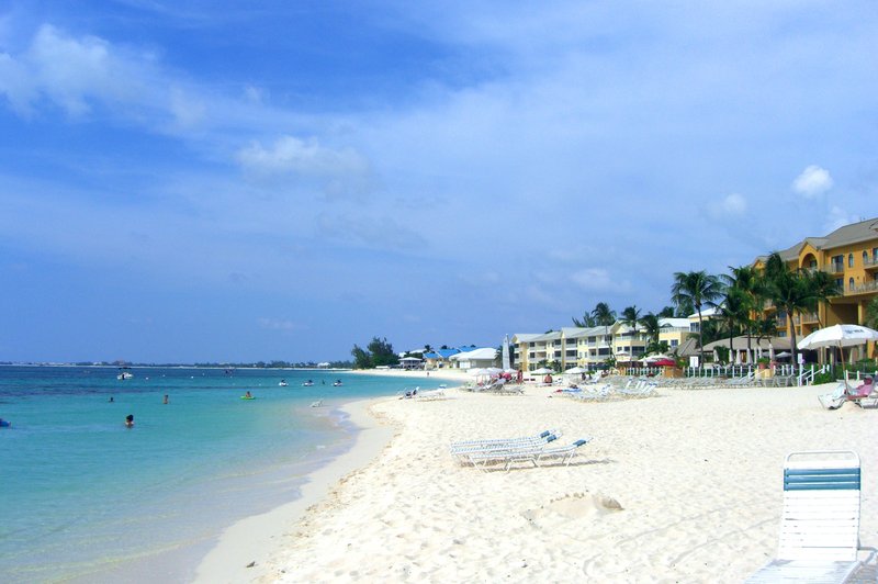 Seven Mile Beach, Grand Cayman, white sand fronting calm turquoise water with resorts along the shore