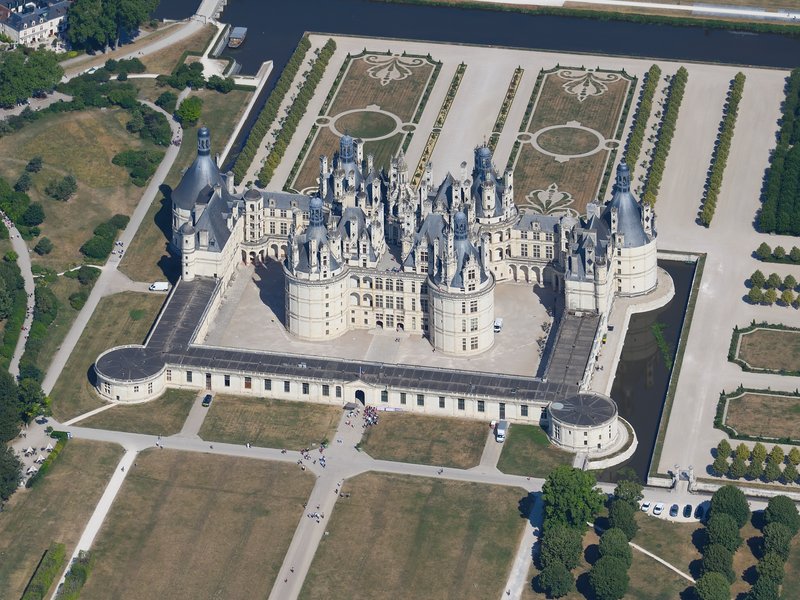 Aerial view of Château de Chambord's turrets and moat in the Loire Valley, France
