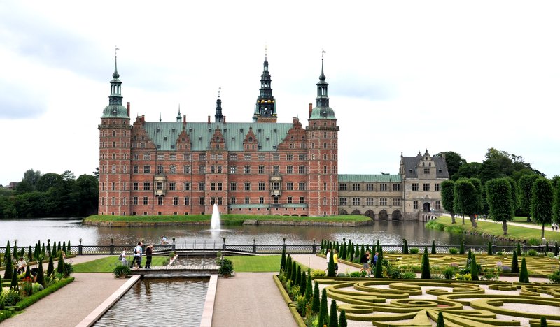 Frederiksborg Castle's red-brick Renaissance towers reflected in the surrounding lake