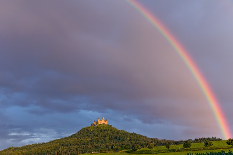 Hohenzollern Castle on its hilltop with a rainbow, Bisingen, Germany