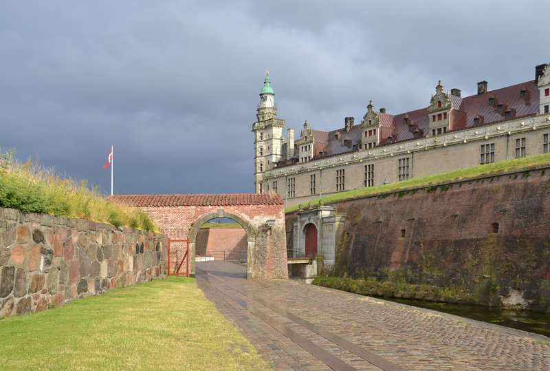 Kronborg Castle's fortified walls, moat, and spired tower guarding the Øresund sound