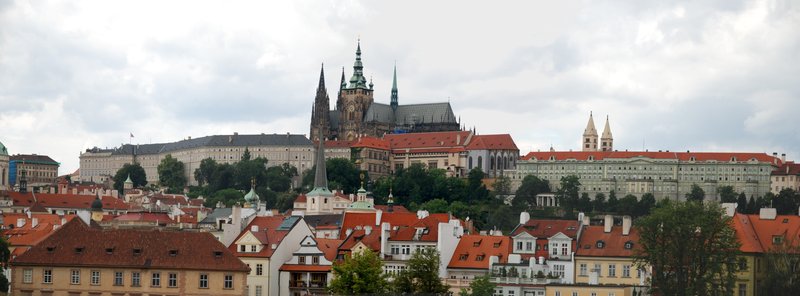 Prague Castle complex with St. Vitus Cathedral spires above the red rooftops of the city