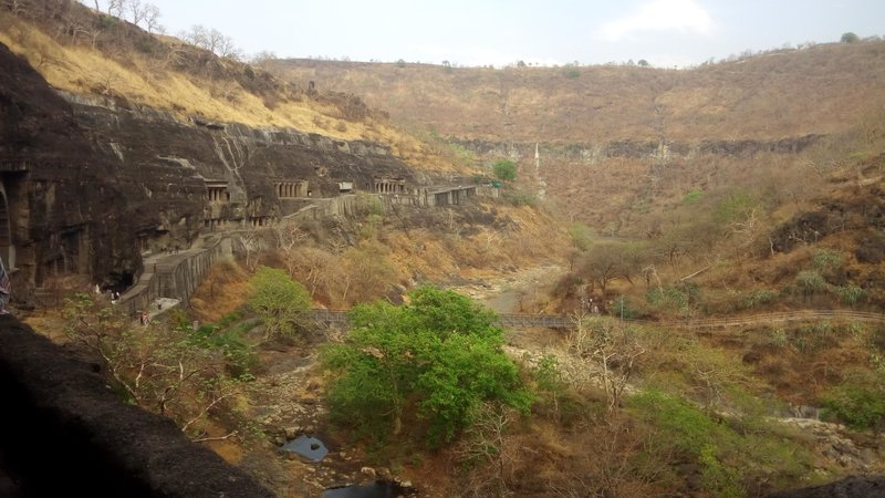 Rock-cut cave facades carved into the horseshoe-shaped cliff at Ajanta