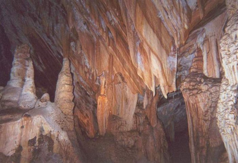 Limestone chamber with draperies and stalagmites inside Jenolan Caves