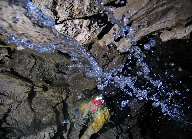 Caver descending a passage inside the Krubera-Voronya cave system, Abkhazia