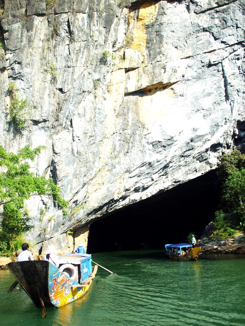 Boats entering the river-cave mouth of Phong Nha Cave