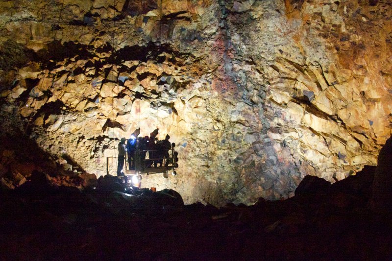 Visitors on a lift platform inside the drained magma chamber of Þríhnúkagígur volcano
