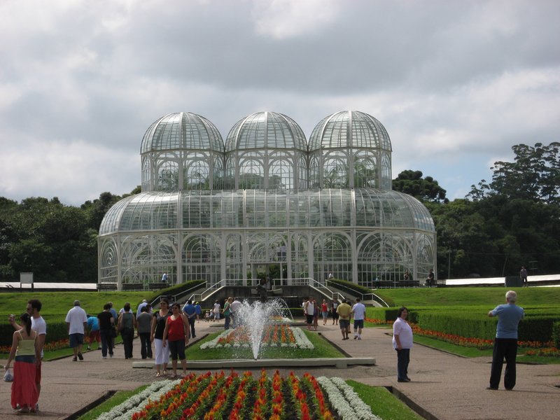 The iron-and-glass greenhouse and formal parterres of the Curitiba Botanical Garden