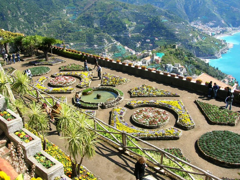 Elevated view of Villa Rufolo's terraced flower gardens overlooking the Amalfi Coast in Ravello