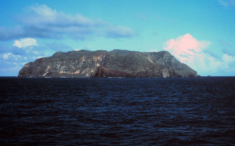Pitcairn Island's cliffs rising from the South Pacific, seen from the sea