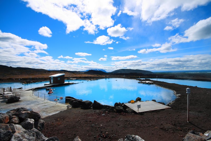 Milky-blue geothermal lagoon at Mývatn Nature Baths surrounded by volcanic terrain, North Iceland