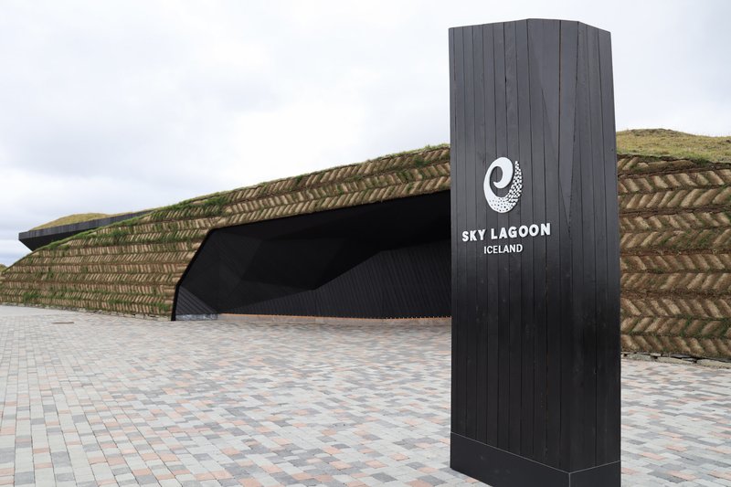 Exterior of Sky Lagoon with turf-roofed building on the edge of Reykjavik