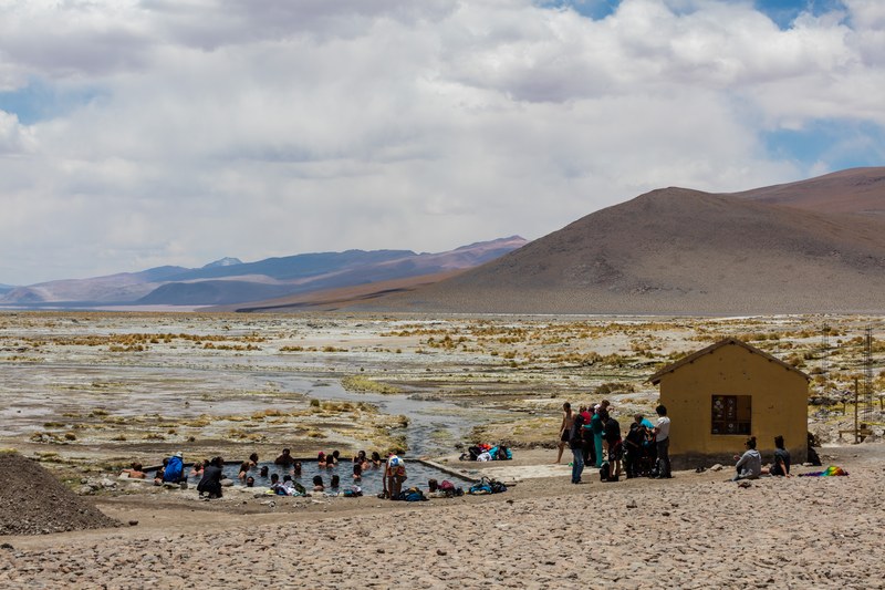 Bathers in the Termas de Polques thermal pool on Bolivia's altiplano