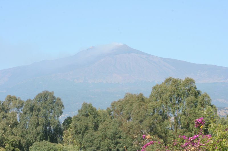 Mount Etna's smoking summit rising above the Sicilian countryside