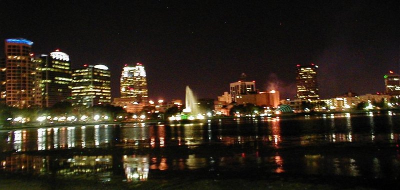 Orlando downtown skyline at night reflected in Lake Eola