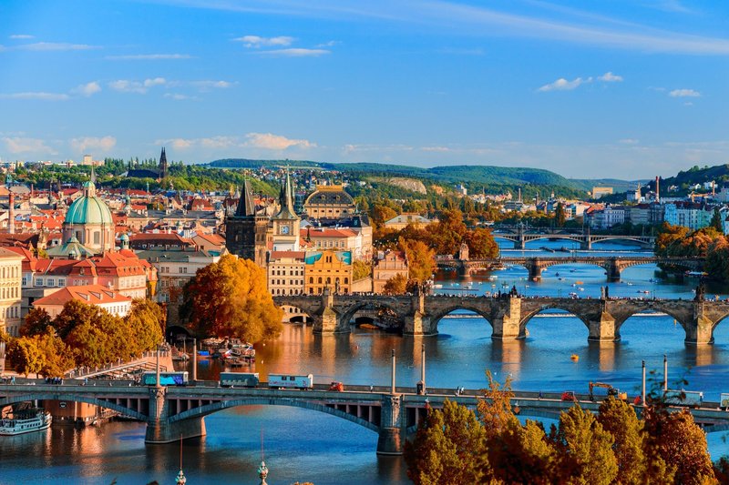 Wide skyline view of Prague showing the city's historic spires and rooftops