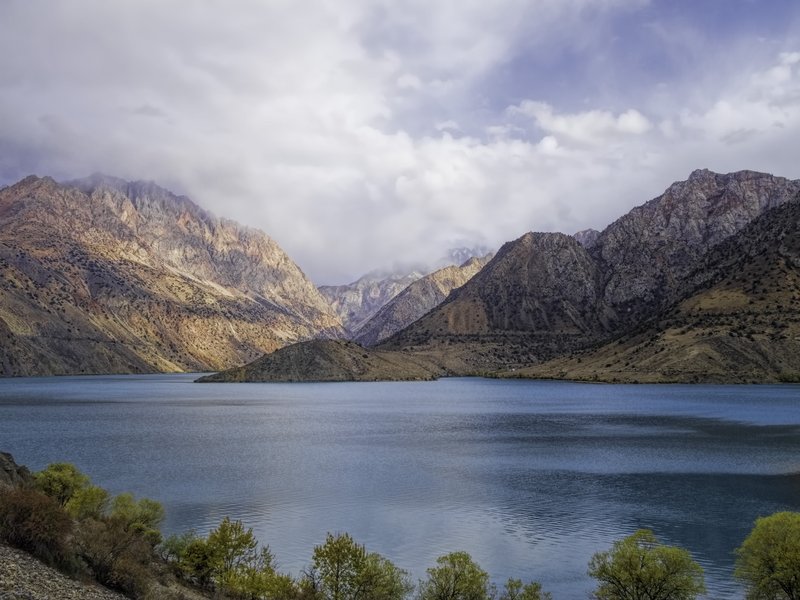 Turquoise Iskanderkul lake amid the Fann Mountains, Tajikistan