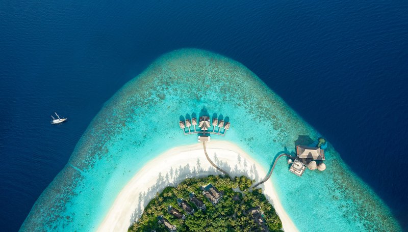 Aerial view of Kihavah island surrounded by vivid turquoise lagoon, Baa Atoll, Maldives