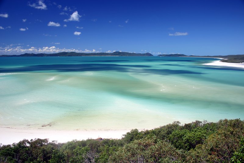 Whitehaven Beach's silica sand swirling into turquoise water, Whitsunday Island, Queensland