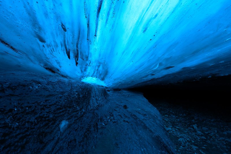 Glowing blue ice cave within the Vatnajökull glacier