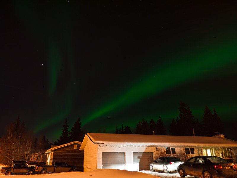 Aurora borealis glowing green over the Whitehorse, Yukon area at night