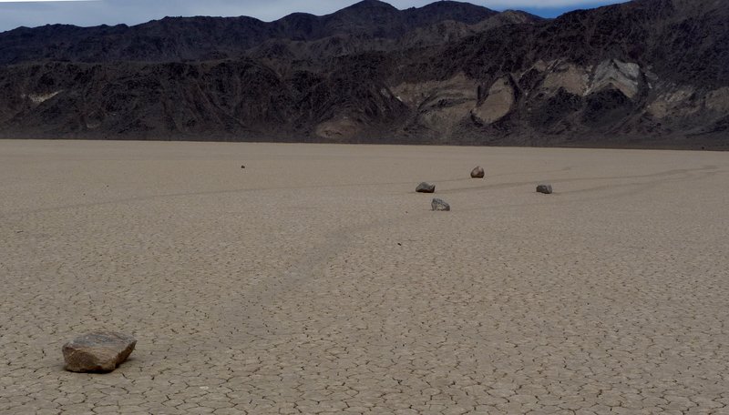Sailing stone tracks crossing the cracked dry lake bed of Racetrack Playa, Death Valley