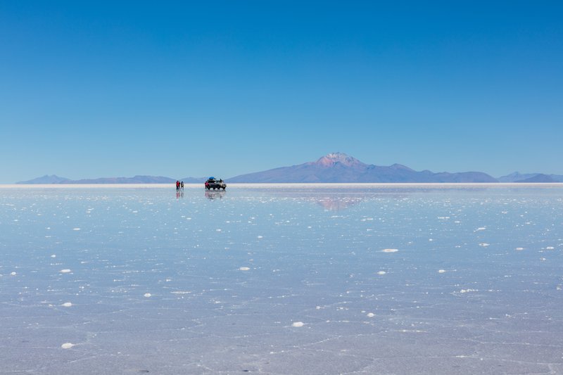 The salt flat's surface reflecting the sky like a mirror after seasonal rains