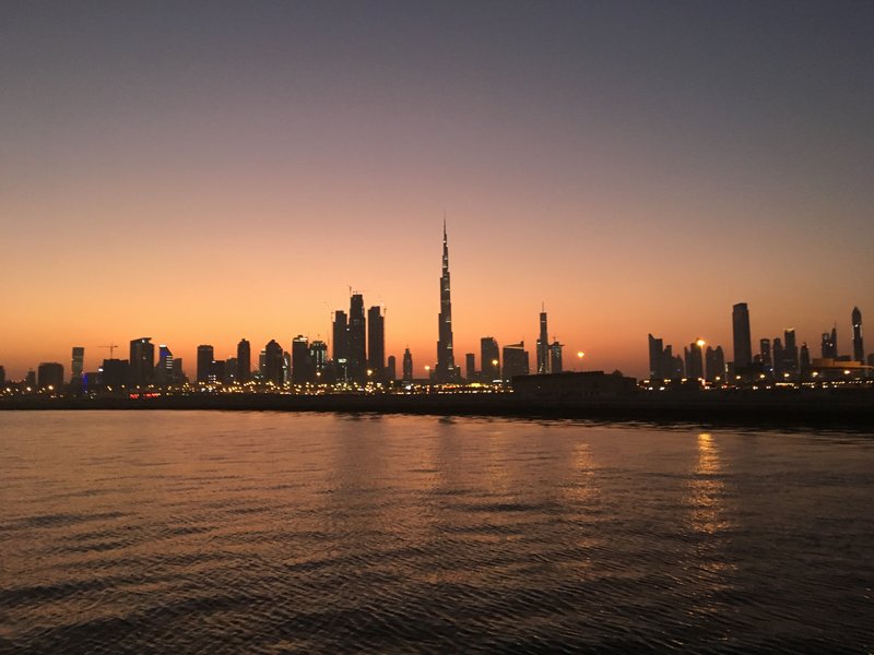 Burj Khalifa silhouetted against a sunset sky over the Dubai skyline