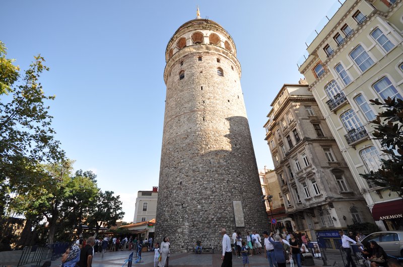 The medieval stone Galata Tower rising above a busy Istanbul square