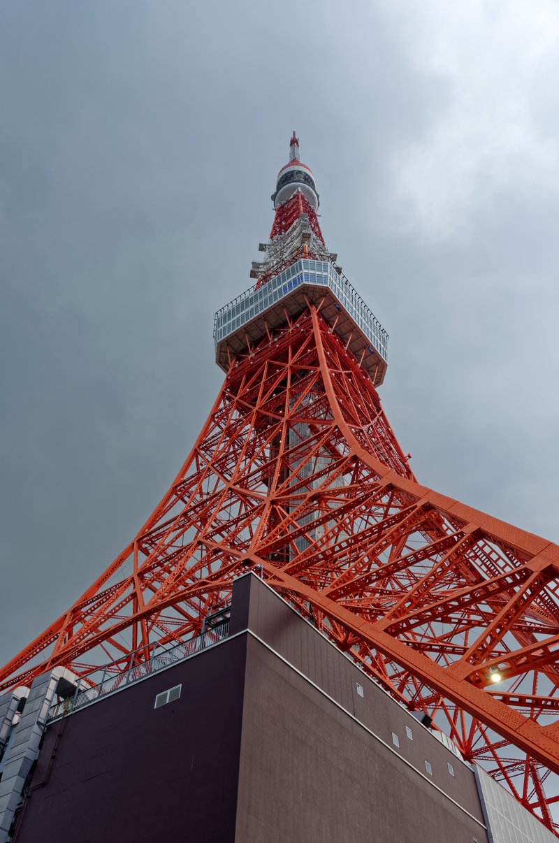 Tokyo Tower's orange-and-white lattice structure seen from below