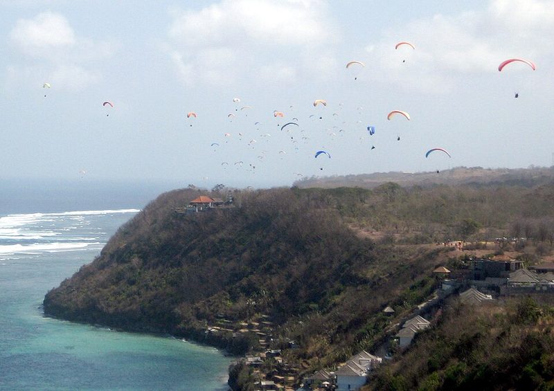 Paragliders soaring the sea cliff at Timbis on Bali's Bukit peninsula