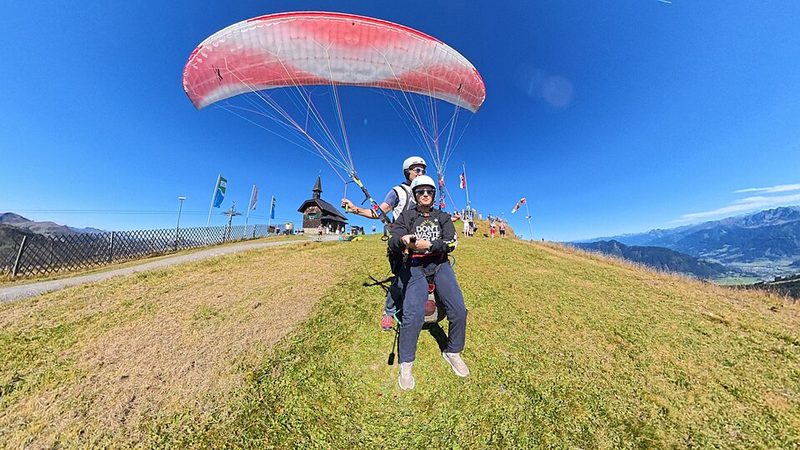 Tandem paraglider launching from the Schmittenhöhe above Zell am See